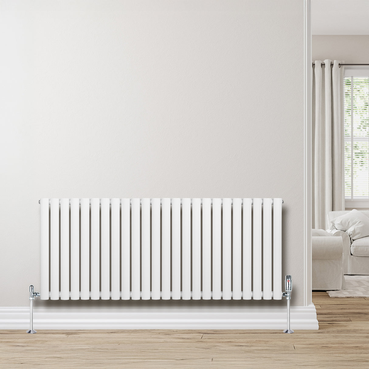 Radiador de coluna oval branco com válvulas, 600 mm x 1440 mm, instalado em parede clara, complementando ambiente moderno e aconchegante