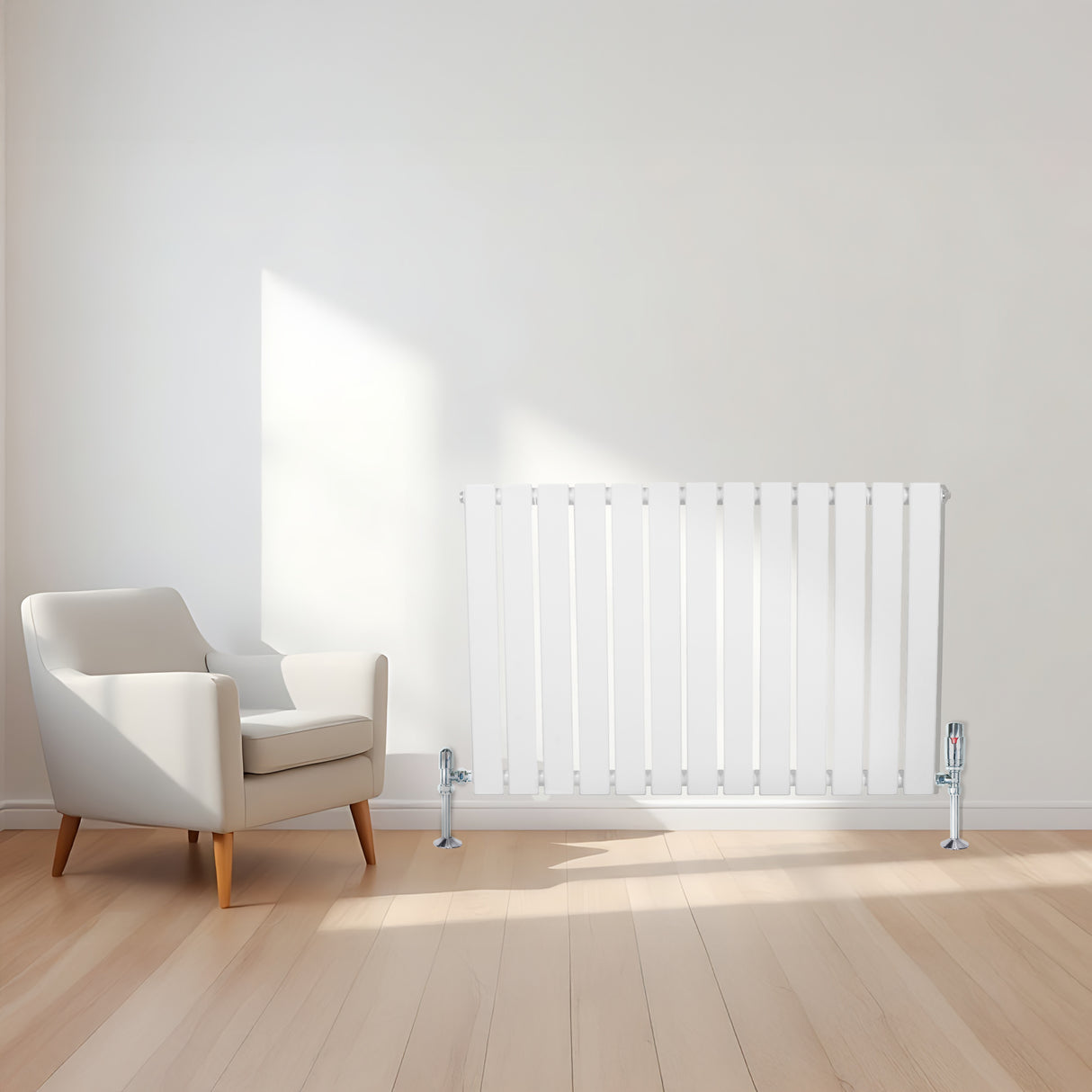 Radiador plano de coluna simples branco com válvulas, instalado em parede clara, ao lado de uma poltrona moderna em ambiente iluminado