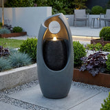 Fonte de água elétrica "Radiant Falls" em formato moderno, cinza, com luz suave e texturas de pedra, ideal para jardins elegantes