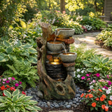 Fonte de água elétrica para jardim "Rustic Brook" com design rústico, pedras cinzas, água fluindo e flores coloridas ao redor