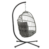 Cadeira suspensa tipo ovo em rattan cinzento, com estrutura metálica preta e almofada acolchoada, ideal para relaxar ao ar livre