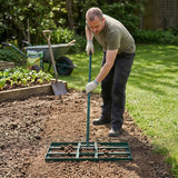 Nivelador de relva verde de 100 cm sendo utilizado por um homem em um jardim, preparando o solo para o plantio com textura uniforme