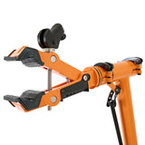 Suporte de oficina para bicicletas em laranja, com garras ajustáveis em borracha para fixação segura e estável da bicicleta