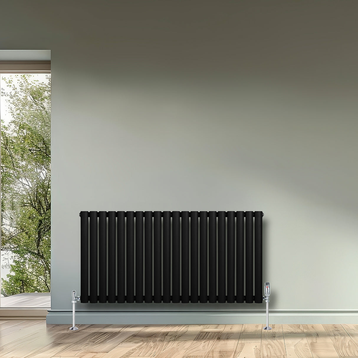 Radiador de coluna simples oval preto, com válvulas, instalado em parede clara, destacando seu design elegante e moderno