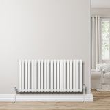Radiador de coluna simples oval branco, 600 mm x 1200 mm, com válvulas, instalado em parede clara, piso de madeira clara