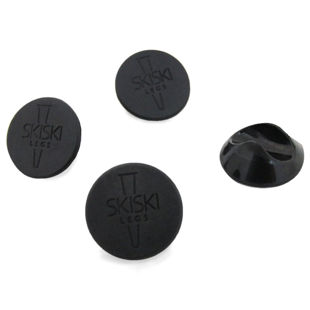 Protetores de pés de mesa em silicone preto, formato redondo, com textura lisa e logotipo SKISKI, ideal para proteger superfícies